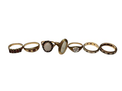 Lot 268 - Seven 9ct gold gem set dress rings to include a synthetic single stone, two opal rings, two garnet rings and two eternity rings