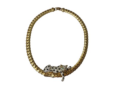 Lot 273 - 1960s gilt metal 'Dutchess of Windsor lounging leopard' necklace with a paste set leopard mounted on a gilt flat curb link chain, 40.5cm long, with a Carolee pouch