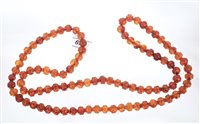 Lot 559 - Unusual Chinese carved amber bead necklace...