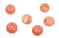 Lot 560 - Six coral beads of circular form,...