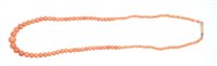 Lot 561 - Coral bead necklace with a string of graduated...