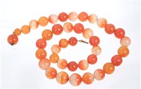 Lot 564 - Carnelian bead necklace with a string of...