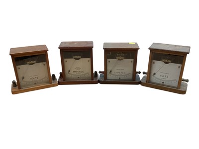 Lot 3015 - Four early 20th century Volts and Amperes gauages in mahogany cases, (4).