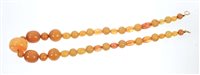 Lot 565 - Old amber bead necklace with a string of...