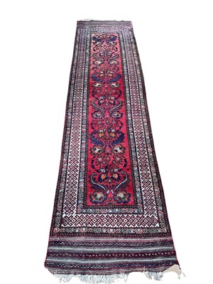 Lot 5407 - Persian runner on red and blue ground. Measurements 364cm x 90cm