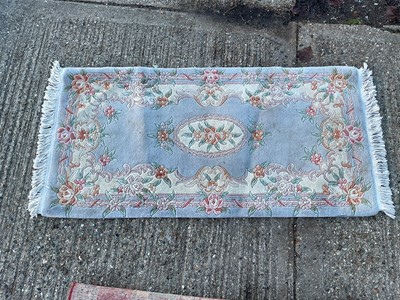 Lot 5409 - Floral Chinese wash rug on blue ground. Measurements 150cm x 77cm