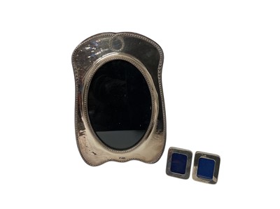 Lot 181 - One silver photograph frame of oval form (Birmingham 1991) together with two contemporary miniature silver photograph frames (3)