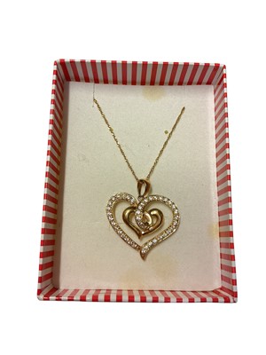 Lot 318 - 18ct gold stylised heart shaped pendant set with synthetic white stones on 18ct gold chain