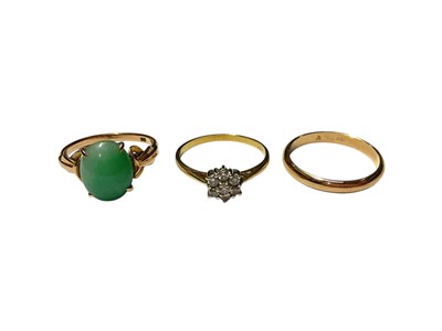 Lot 330 - 18ct gold diamond flower head cluster ring, jade/ green hardstone cabochon ring in setting marked 14K and a yellow metal wedding band (3)