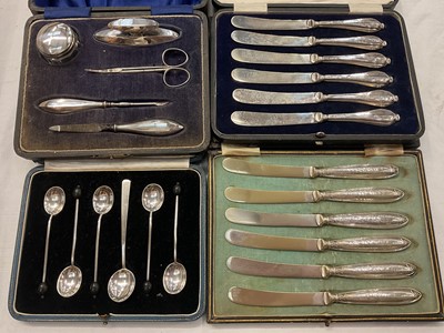 Lot 937 - Two sets of six silver handled butter knives, silver mounted manicure set and a set of five silver coffee bean end spoons and one other silver spoon, all in fitted cases