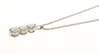 Lot 447 - Diamond three stone pendant in white gold setting on white gold chain