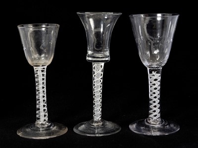 Lot 37 - Three Georgian opaque twist stem wine glasses, including two with fluted funnel bowls and one with bell shaped bowl, 13.75cm to 15cm high