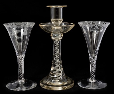 Lot 38 - A pair of 18th century style air twist wine glasses with etched swags, Bonhams label attached, 17.75cm high, together with an opaque twist stem candlestick, 23cm high, all probably continental...