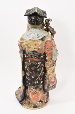 Lot 32 - Large antique Japanese Satsuma figure of an Immortal, brightly decorated, 49cm high