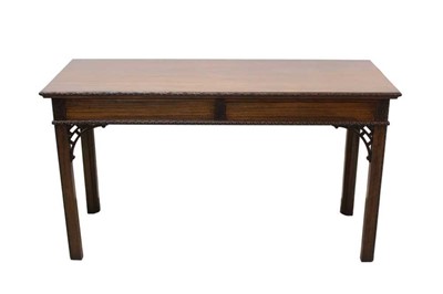 Lot 1290 - Chippendale style mahogany serving table, the rectangular top with ribbon and floral carved edge, two flush drawers to the frieze on square legs and pierced brackets, 152cm wide x 60cm deep x 86...