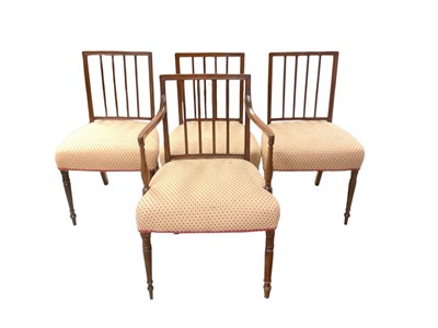 Lot 1399 - Four George III mahogany dining chairs with reeded backs, upholstered seats and turned legs, comprising three standards and one carver