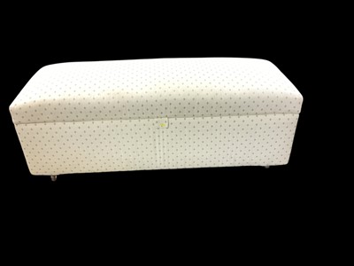 Lot 1406 - Contemporary upholstered ottoman with rising lid, on castors, in patterned fabric