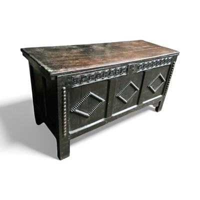 Lot 1306 - 17th century carved oak coffer, with internal candle box and guilloché carved frieze and triple panel front with reel moulded ornament on stiles, 123cm wide x 48cm deep x 65cm high