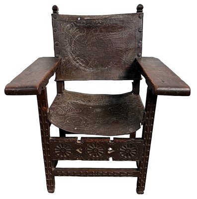Lot 1410 - 17th century Spanish carved wood and tooled leather chair.