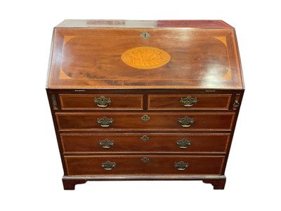 Lot 1310 - George III mahogany and satinwood inlaid bureau, the hinged fall centred shell patera enclosing fitted interior, with two short over three long graduated drawers on bracket feet, 108cm wide x 57...