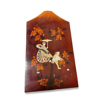 Lot 5040 - Japanese lacquered shibayama plaque, decorated in bone and mothe of pearl with a man pulling a woman in a rickshaw, in front of a mountain, 36cm x 20.5cm