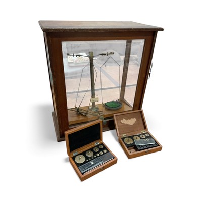 Lot 5148 - Chemical balance scales in glazed cabinet and two sets of weights