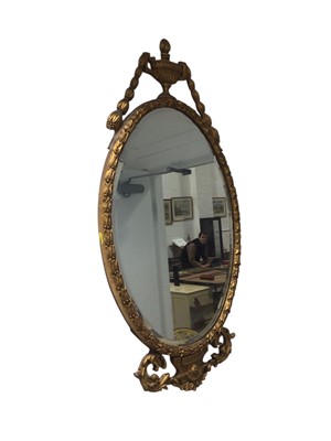 Lot 5297 - Classical style oval gilt mirror with scroll and urn ornament