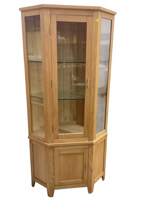 Lot 1314 - Contemporary light oak two height display cabinet with panelled door below.