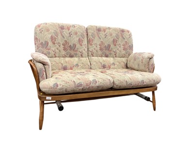 Lot 1315 - Ercol three piece suite with loose floral cushions