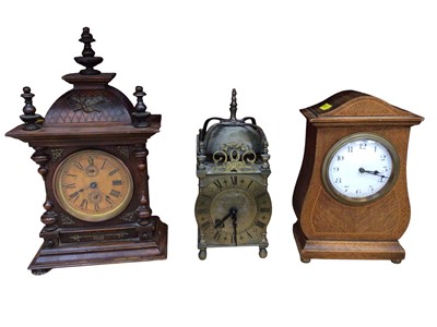 Lot 729 - French line inlaid oak mantle clock with enamel dial, reproduction lantern clock, and another mantle clock with turned baluster columns