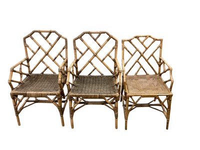 Lot 1340 - Pair of 1920s wicker conservatory chairs, with retailers label to underside and a similar chair