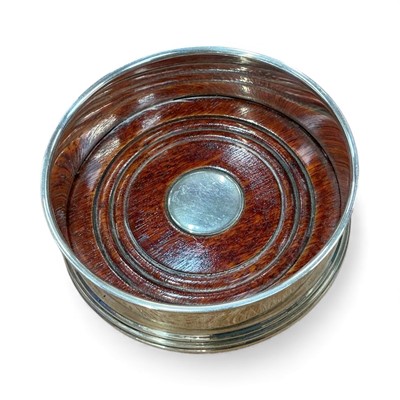 Lot 960 - Contemporary silver wine coaster with turned wood base