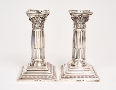 Lot 200 - Pair late Victorian silver candlesticks with Corinthian columns, on weighted, square stepped bases