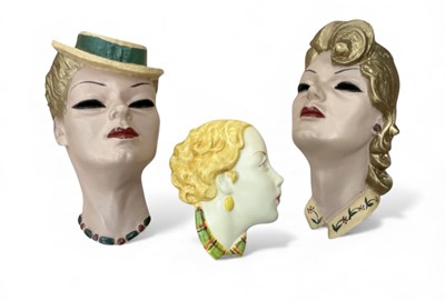 Lot 432 - Pair of plaster profile wall busts of ladies and another similar