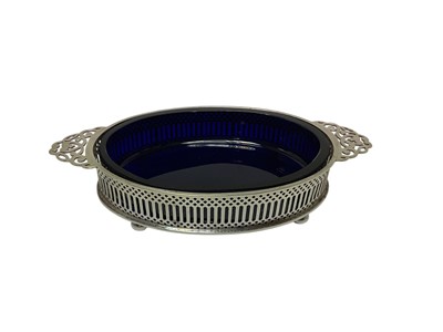 Lot 205 - 1920s silver twin handled dish of oval form, with pierced border and blue glass liner