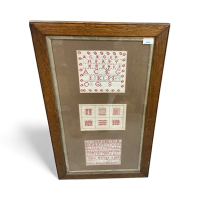 Lot 499 - Victorian girls sampler- Girls School Epsom, 1880, with darning and alphabet, in glazed oak frame.