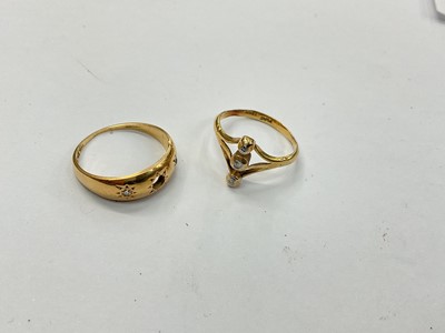 Lot 903 - 18ct gold and diamond gypsy ring (central diamond missing) and an 18ct three-stone ring (2)