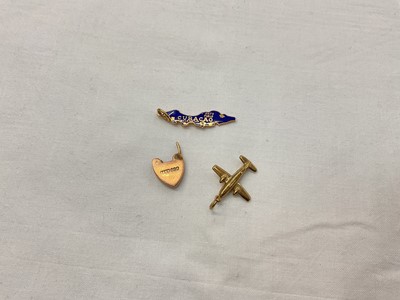 Lot 925 - 9ct gold plane and padlock charms (padlock broken) and a yellow metal 'Curacao' charm with Chinese mark