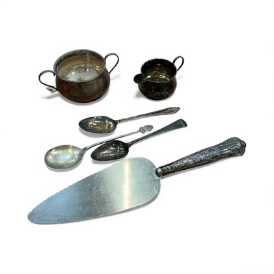 Lot 930 - Silver cream jug, silver sugar bowl, silver handled cake slice and three silver spoons, together with a small group of plated ware.