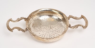 Lot 217 - George III silver twin handled strainer, with pierced bowl (marks rubbed). .