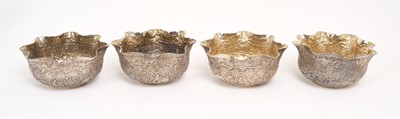 Lot 219 - Set of four late 19th / early 20th century silver dishes with embossed jungle scene decoration