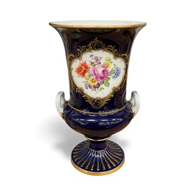 Lot 41 - Meissen campana shaped vase, painted with flowers on a cobalt blue and gilt ground, marks to base, 23.5cm high