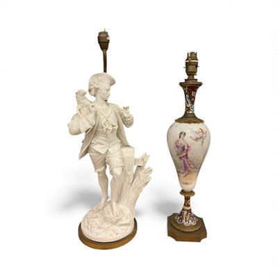 Lot 43 - Two continental porcelain lamps, including one blanc de chine in the form of a shepherd and sheep, the other with figural decoration to the porcelain body, with champleve enamel decoration to ne...