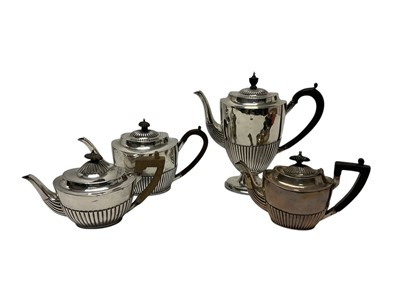Lot 223 - Victorian silver tea and coffee pot, with half fluted decoration and ebony handles (Sheffield 1891)