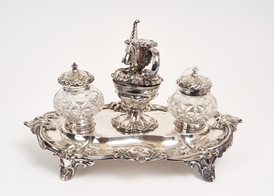 Lot 224 - Late Victorian silver standish, of shaped oval form, with foliate borders, on four scroll feet