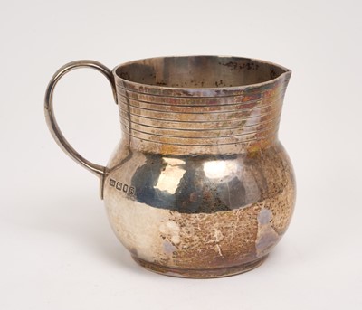 Lot 225 - 1930s silver cream jug of baluster form, with reeded decoration and plain loop handle