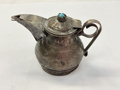 Lot 991 - Eastern white metal jug with hinged cover and engraved decoration, 8cm high
