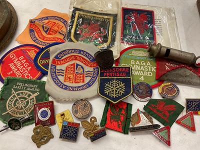 Lot 337 - Collection of vintage swimming cloth badges, other badges, shell case candlestick and John Leckie Ltd compass