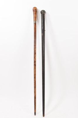 Lot 741 - Two torch walking sticks