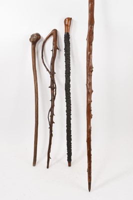 Lot 750 - Group of four antique rustic walking sticks, including a root wood stick, hawthorn sticks, etc